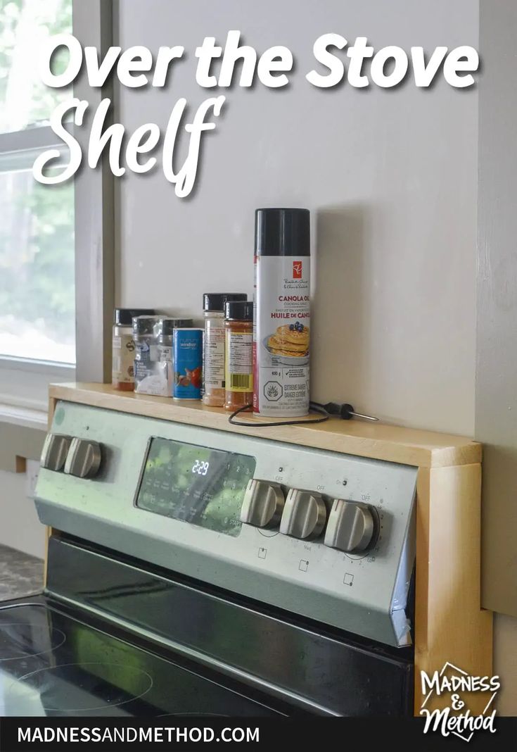 a stove top oven sitting in front of a window with spices on it and the words over the stove shelf above it