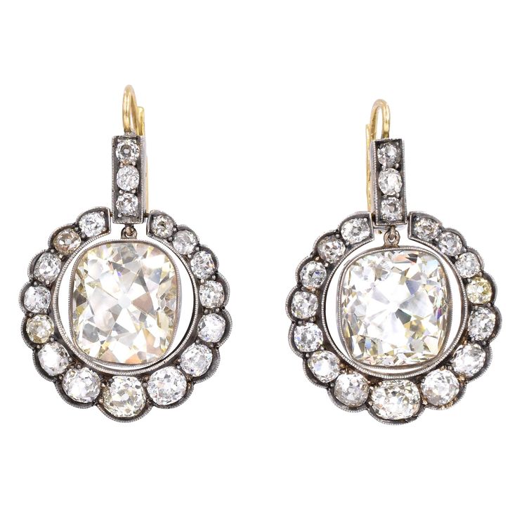 Stunning Victorian drop earrings! 36 gradual old European diamonds set in gold & silver in a circular shape & filigree workmanship, with estimated total weight of 8 carats Center diamonds are: Shape: Old Cushion Shape Weight: 12.88 carat & 10.29carat each Diamonds are set in an intricate mounting and completed by 18k gold wire and lever back closure Victorian Drop Earrings, Diamond Ribbon, Vintage Drop Earrings, Diamond Earrings Studs Round, Platinum Earrings, Cushion Cut Diamonds, Victorian Jewelry, Antique Earrings, Lovely Jewellery