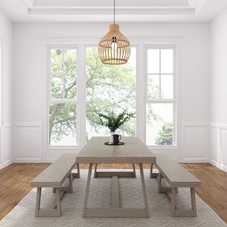 a dining room with a table and bench in front of two windows, potted plant on the far end