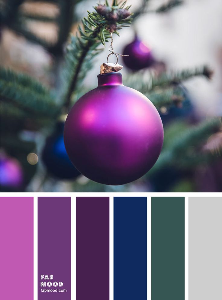 a purple christmas ornament hanging from a tree