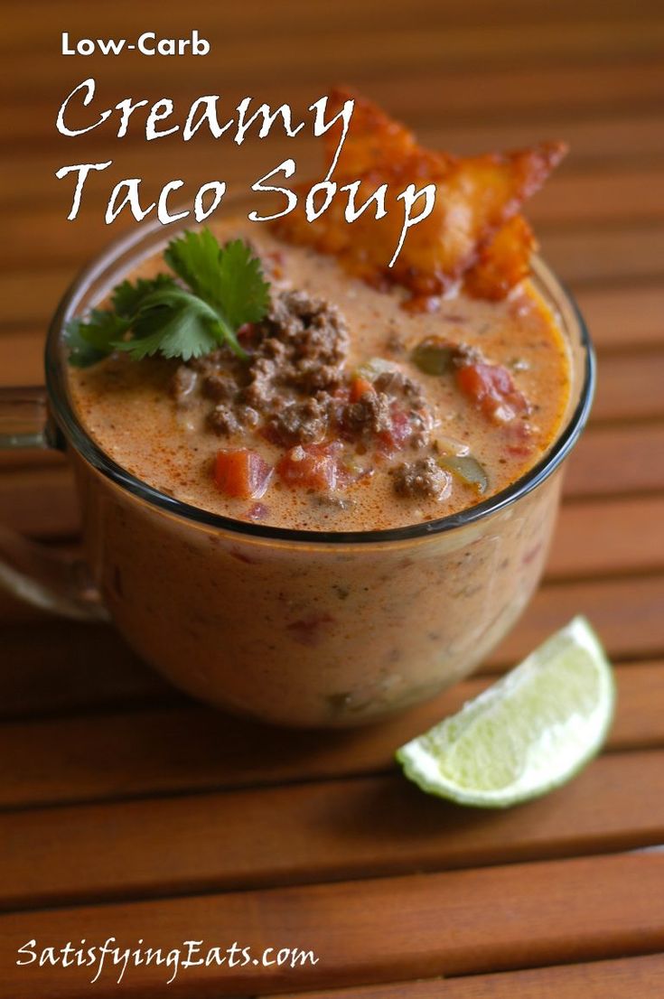 creamy taco soup in a glass with lime wedges on the side and text overlay that reads low carb creamy taco soup