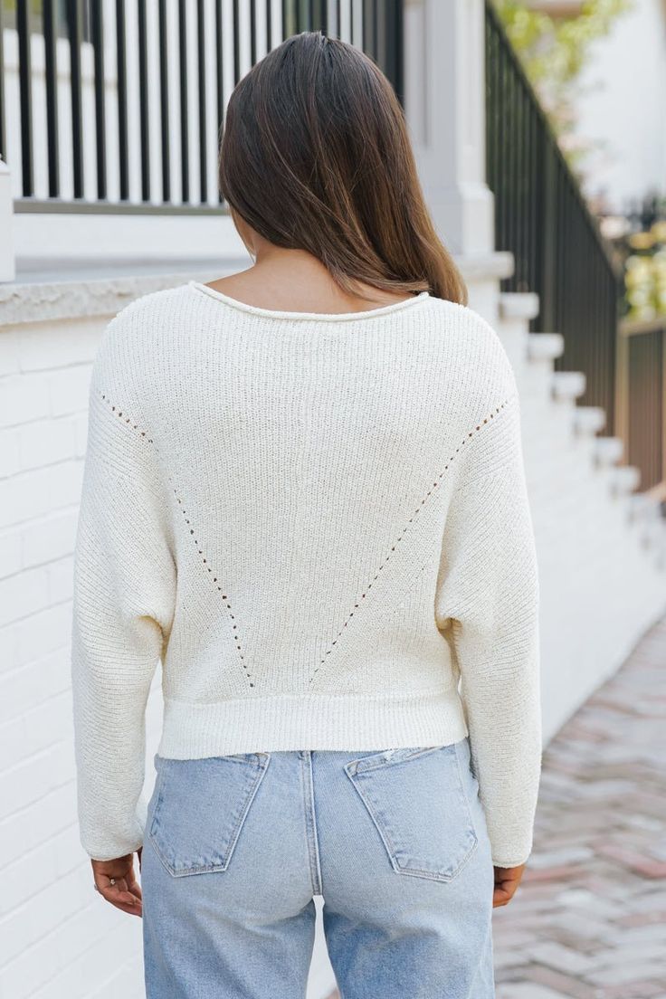 Expertly crafted from 100% polyester, this Cream Boat Neck Pointelle Sweater offers both comfort and style! Its unique design features a rolled collar and cuffs, long dolman sleeves, and a ribbed knit banded hem for a relaxed fit. Perfect for any occasion, it's a must-have addition to your wardrobe! Style with your favorite jeans or shorts along with some sneakers and simple gold jewelry for a casual chic everyday look. Relaxed Fit Long Sleeve Cropped Sweater In Soft Knit, Casual Relaxed Fit Cropped Sweater For Spring, Fall Cotton Cropped Sweater With Ribbed Neckline, Fall Cropped Cotton Sweater With Ribbed Neckline, Spring Relaxed Fit Knit Cropped Sweater, Relaxed Fit Knit Cropped Sweater For Spring, Spring Ribbed Sweater With Batwing Sleeves, Spring Textured Knit Sweater In Relaxed Fit, Spring Textured Knit Cropped Sweater With Relaxed Fit