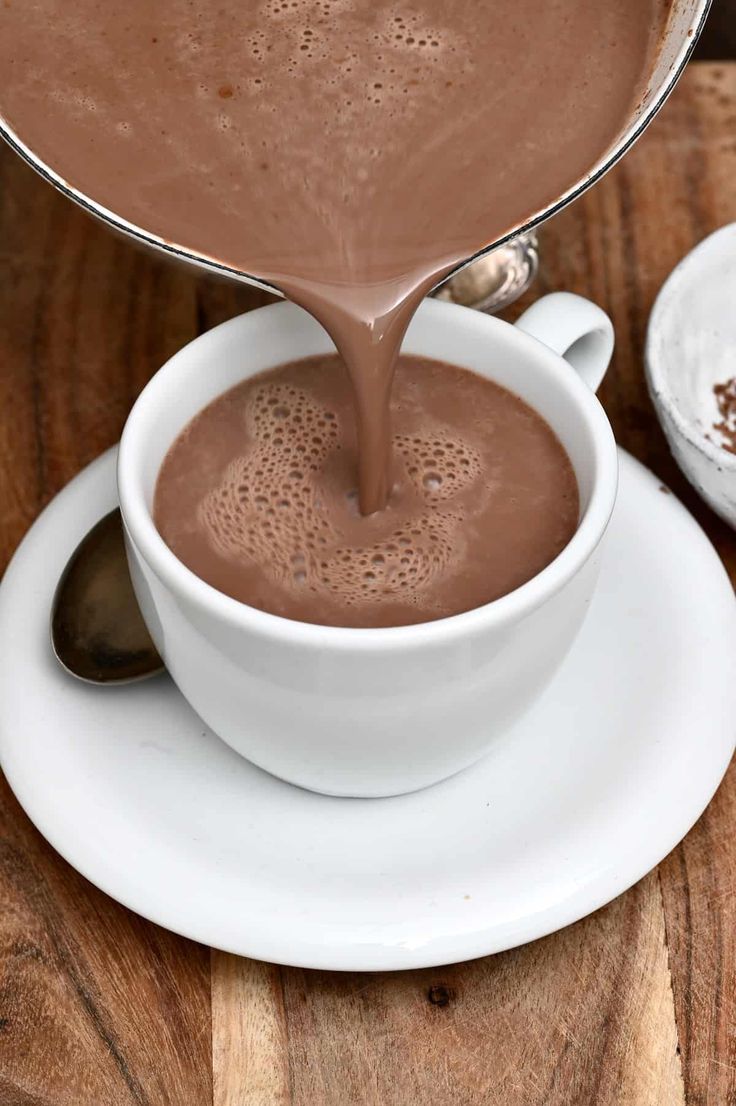 chocolate being poured into a white cup