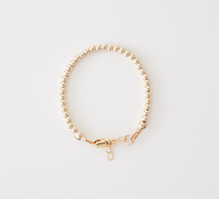 "This baby bracelet is made with high quality 14k gold filled beads, lobster clasp, and extender that won't tarnish and will resist most wear and tear, with the right care. We highly recommend measuring your babies wrist for the best fit. Take a measuring tape and measure wrist tightly around (in inches). Add 1/2 inch and that's the size you should order. Each bracelet comes with extra links that extend 1/2 inch beyond the size you order. If you are buying as a gift, this chart is a good guideli Adjustable Rose Gold Beaded Bracelets In 14k Gold, Everyday 14k Gold Filled Bracelet With Round Beads, Adjustable 14k Gold Beaded Bracelets, Nickel-free Gold Name Bracelet For Everyday, Adjustable 14k Gold Beaded Bracelets With Tiny Beads, Adjustable Yellow Gold Bracelets, Dainty Gold Name Bracelet With Round Beads, Dainty Gold Beaded Name Bracelet, Dainty Rose Gold Bracelet With Round Beads