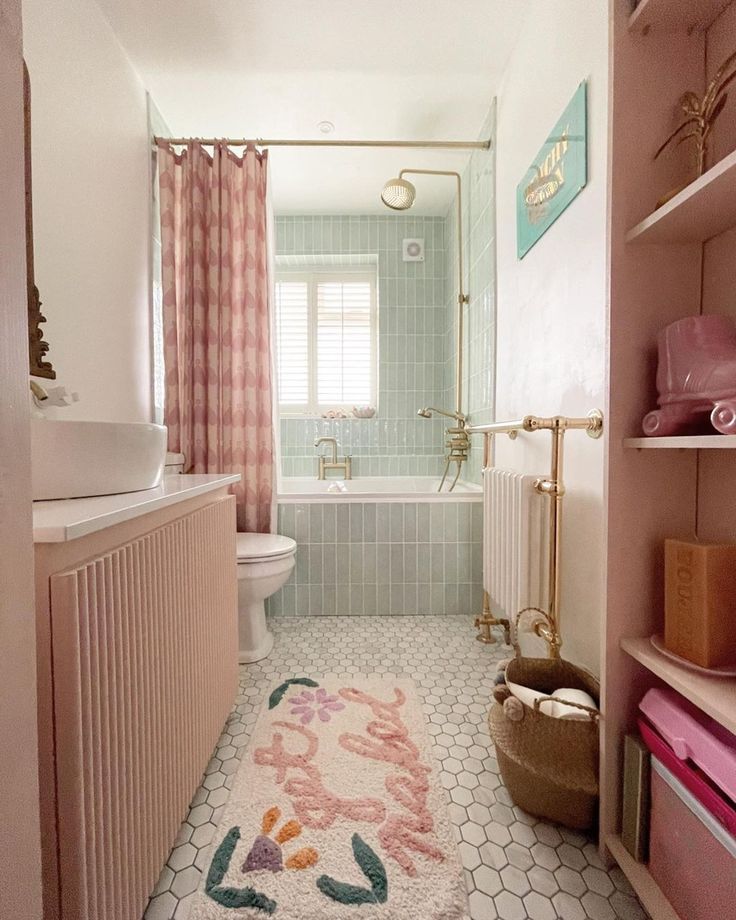 a bathroom with pink and white decor in the bathtub, shower curtain, rug on the floor