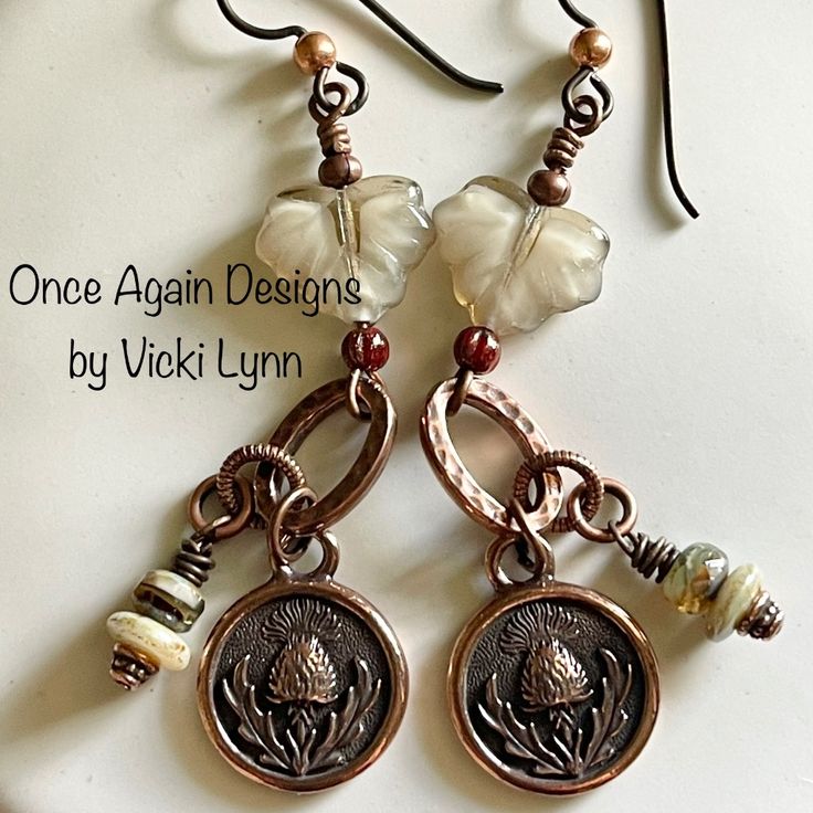 “Thistle While You Work” In Copper - Dangle Earrings Hand Created - Once Again Designs By Vicki Lynn Limited Edition Earrings Featuring Czech Glass Beads And Sweet Thistle Coin Charms. This Pair: - Czech Glass Leaves And Beads. - Tierracast Antique Copper (Plated) Thistle Coin Charms And Findings. - Tierracast Niobium Hypoallergenic French Hook Ear Wires With Copper Bead. - Length: Approximately 2-3/4” From Top Of Ear Wire. - Packaged In A Handmade Drawstring Pouch In A Complimentary Design And