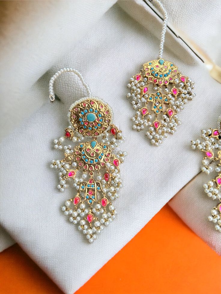 This multani work thapa kundan tikka and jhumka earrings set is gorgeous and very versatile to wear. The gold plating is traditional and the colors will match with any type of outfit. Kundan Tikka, Kundan Set, Authentic Indian, Jhumka Earrings, Earrings Set, Indian Jewelry, Gold Plating, Lehenga, Earring Set