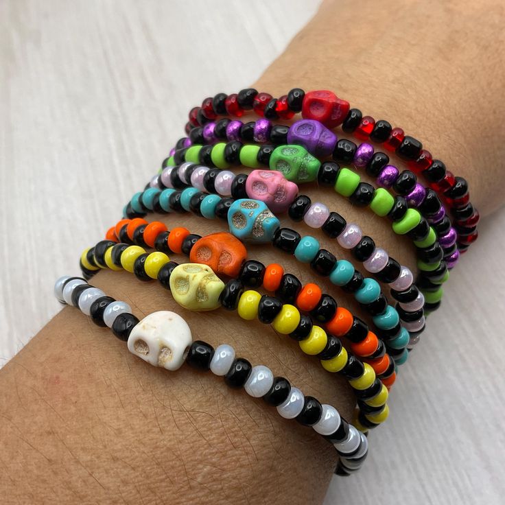 These colorful Halloween skull Stretch bracelets are handcrafted personally for me, Derlis. You can pick your size bracelet. Also, you can pick your favorite style, color combination, with or without skull, and make your own stack. A wonderful gift to your friends, family to wear this Mardi Gras, Halloween season/parties/parades and/or as part of your costume, to go trick or treating, or all year round.  Do not forget to get the matching earrings: https://www.etsy.com/listing/1544063575/hallowee Casual Adjustable Skull Beaded Bracelets, Halloween Skull Print Bracelet Gift, Adjustable Skull Print Bracelet As Gift, Handmade Casual Skull Bracelets, Handmade Casual Skull Bracelet, Casual Handmade Skull Bracelets, Handmade Skull Bracelet As A Gift, Novelty Multicolor Beaded Bracelets For Halloween, Halloween Novelty Multicolor Beaded Bracelets