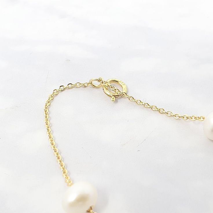 Our Freshwater Pearl Double Chain Wedding Bracelet, crafted with 18ct gold-plated copper and adorned with freshwater pearls, is the perfect elegant gift for brides, bridesmaids, or any special occasion.  Elevate your bridal ensemble with our Freshwater Pearl Double Chain Wedding Bracelet, an exquisite accessory perfect for bridesmaids or brides on their special day.   This jewellery arrives beautifully packaged and ready to gift. It would make a really thoughtful and meaningful birthday gift, Ch Delicate Gold Chain Bracelet With Pearls, Classic Gold Bracelets With Pearl Charm, Classic Gold Bracelet With Pearl Drop, Dainty Gold Pearl Bracelet With Pearl Charm, Elegant Single Strand Baroque Pearl Bracelets, Luxury Gold Akoya Pearl Bracelet, Luxury Gold Pearl Necklace For Wedding, Wedding Baroque Pearl Chain Bracelet, Refined Gold Wedding Jewelry