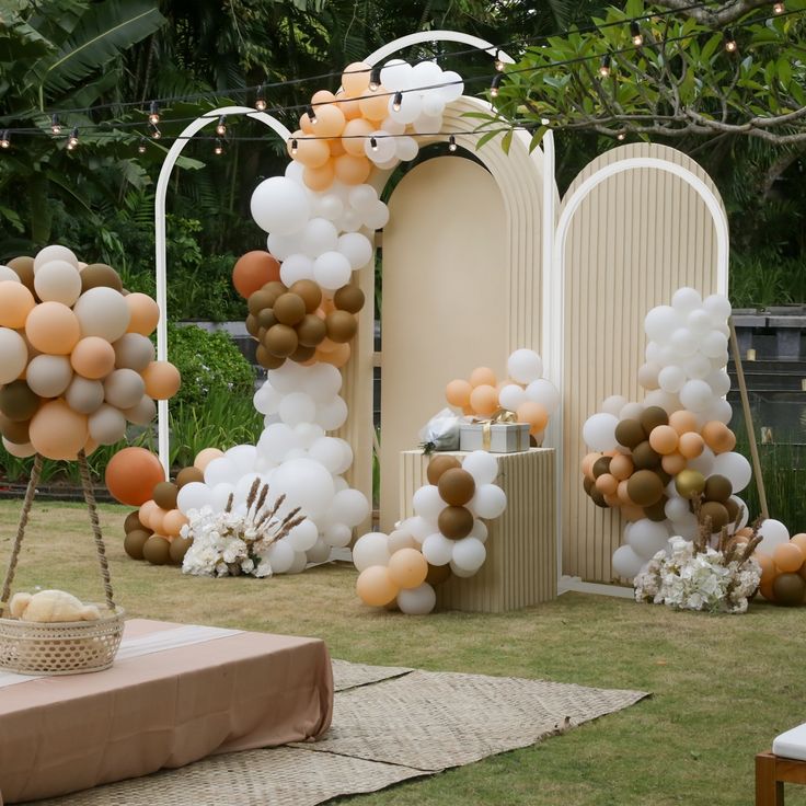 an outdoor party with balloons and decorations