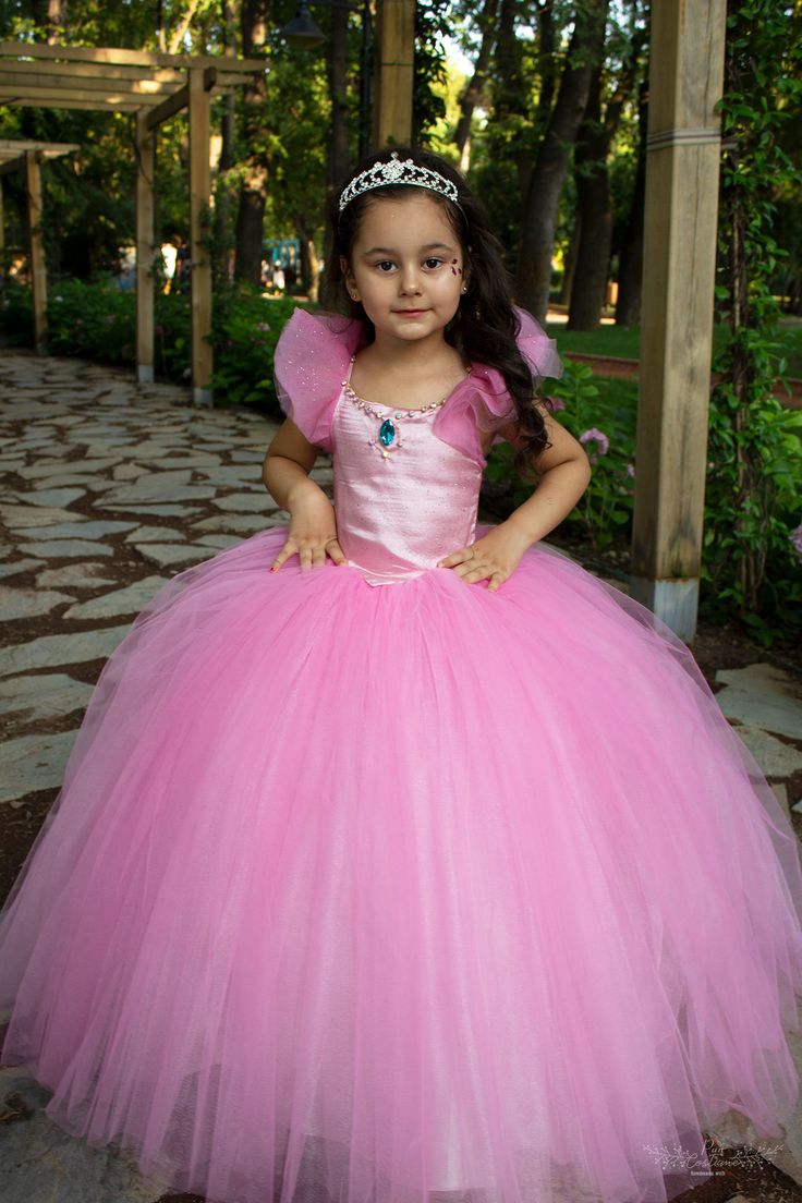 Here is our Rubies Pink Princess Dress, excellent for a Flower Girl! This fluffy court train rubies pink party gown is a great choice for toddler bridesmaid dress and junior wedding dress, as well as for pageants, birthdays, photo shootings and many other special occasions. It is made of dream tulle, crystal tulle, glitter printed crystal tulle, greek tulle and satin. It has a built-in petty coat for a fluffier look and embellished with bright rhinestone. The back of the tutu dress has lace-up s Pink Princess Dress Kids, Princess Dresses Kids Ball Gowns, Pink Princess Costume, Baby First Birthday Dress, Pink Princess Dress, Flower Girls Dress, Tutu Party, Dress Couture, Elegant Ball Gowns