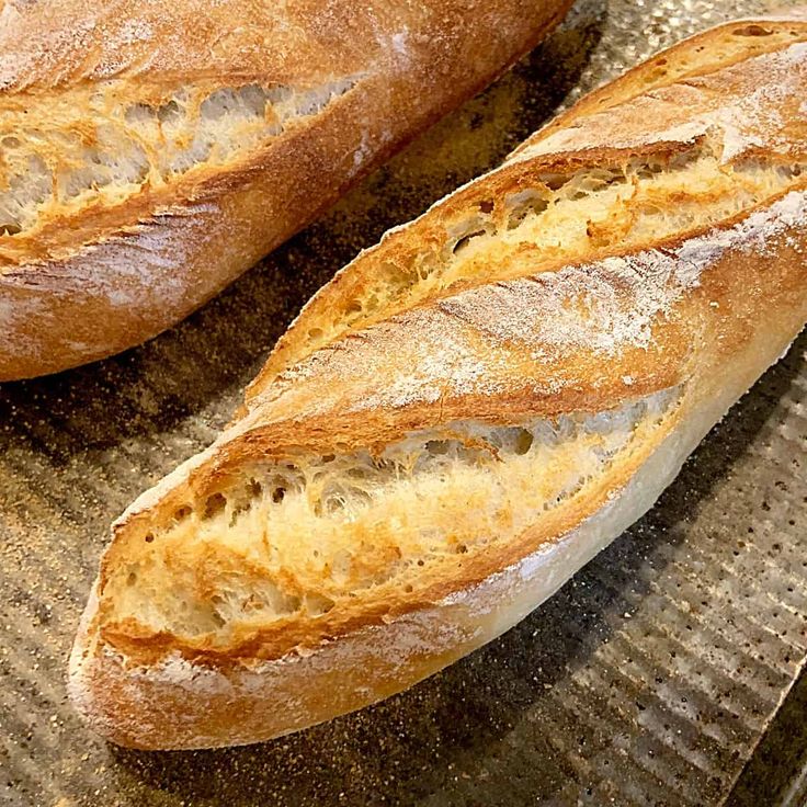 two loaves of bread sitting on top of a pan