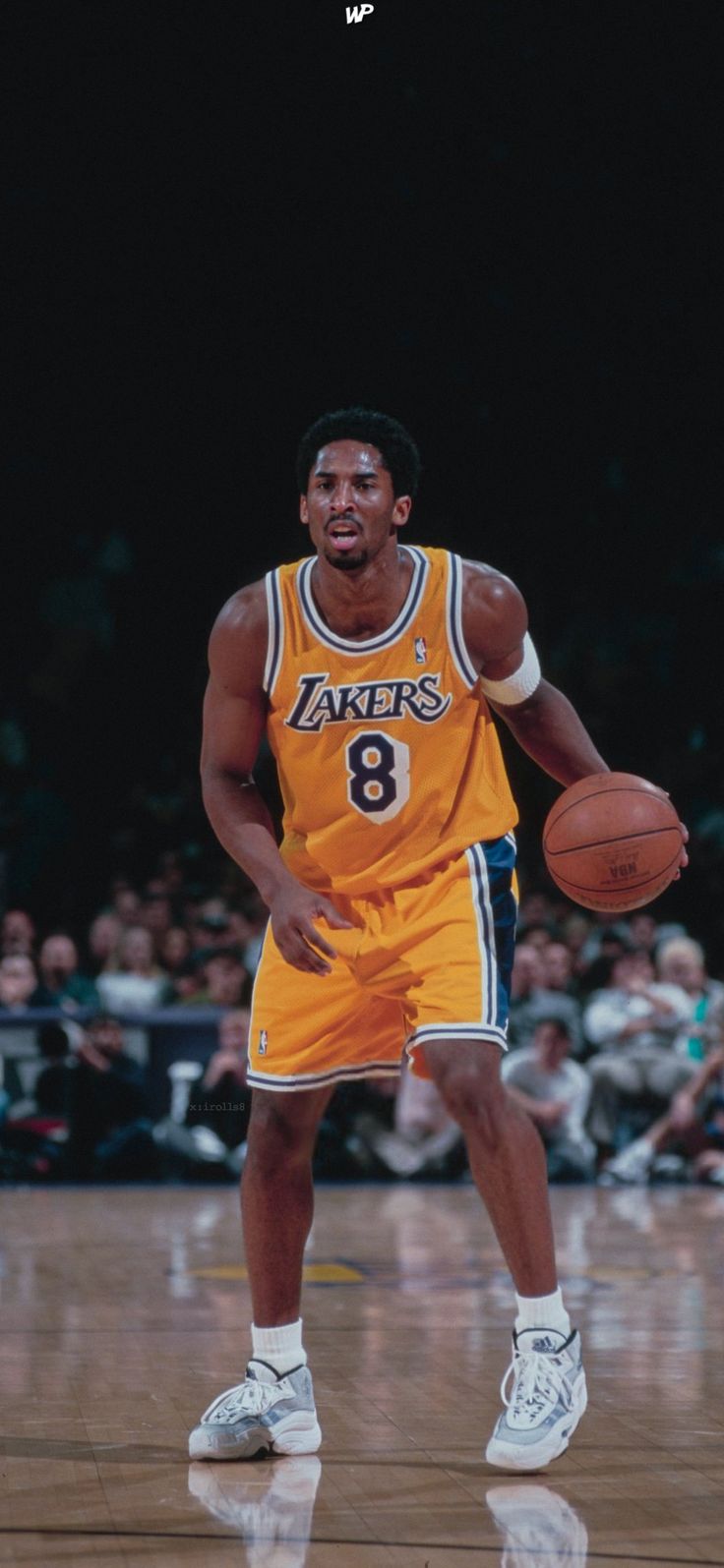 a man holding a basketball on top of a court