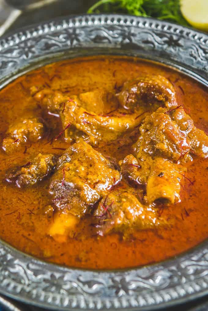 chicken curry served in a bowl with garnish