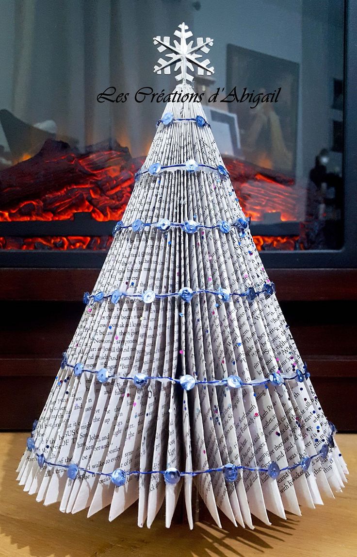 an origami christmas tree made out of newspapers