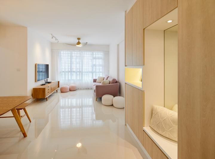 a living room filled with furniture and a flat screen tv on top of a wooden cabinet