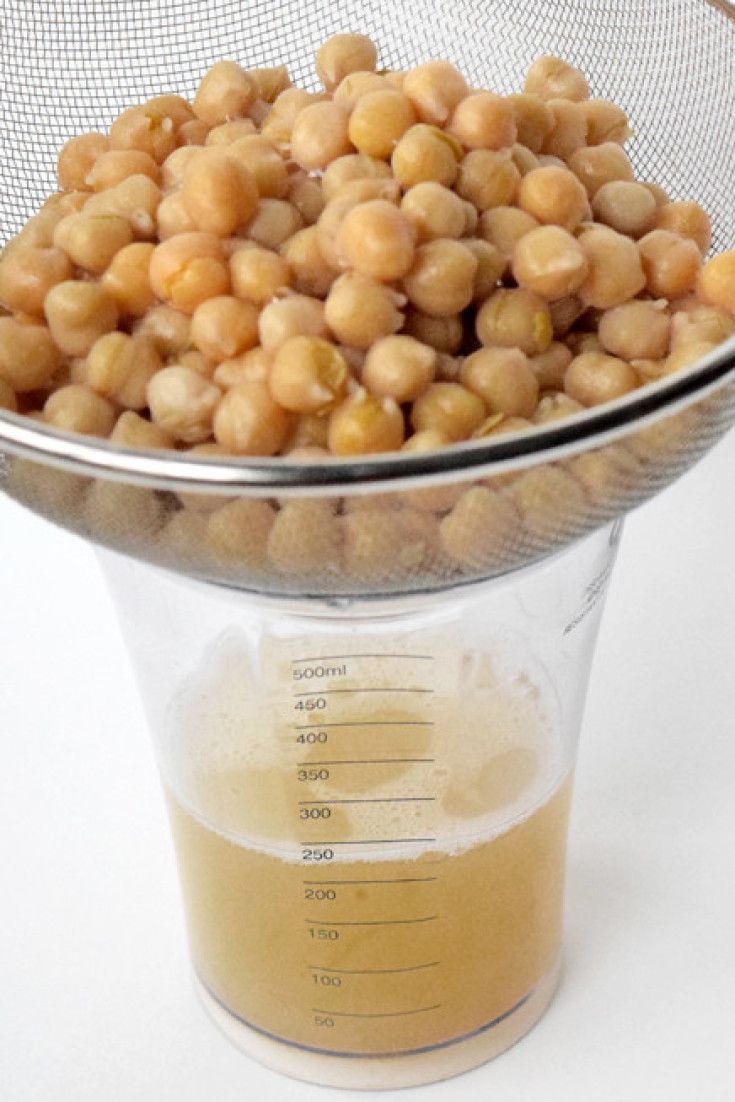 a glass measuring cup filled with chickpeas