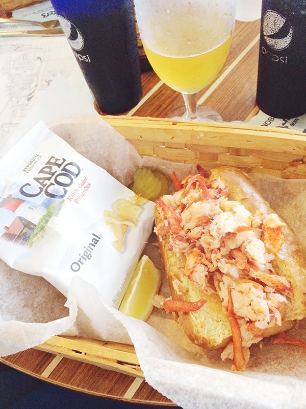 a basket filled with food and drinks on top of a table