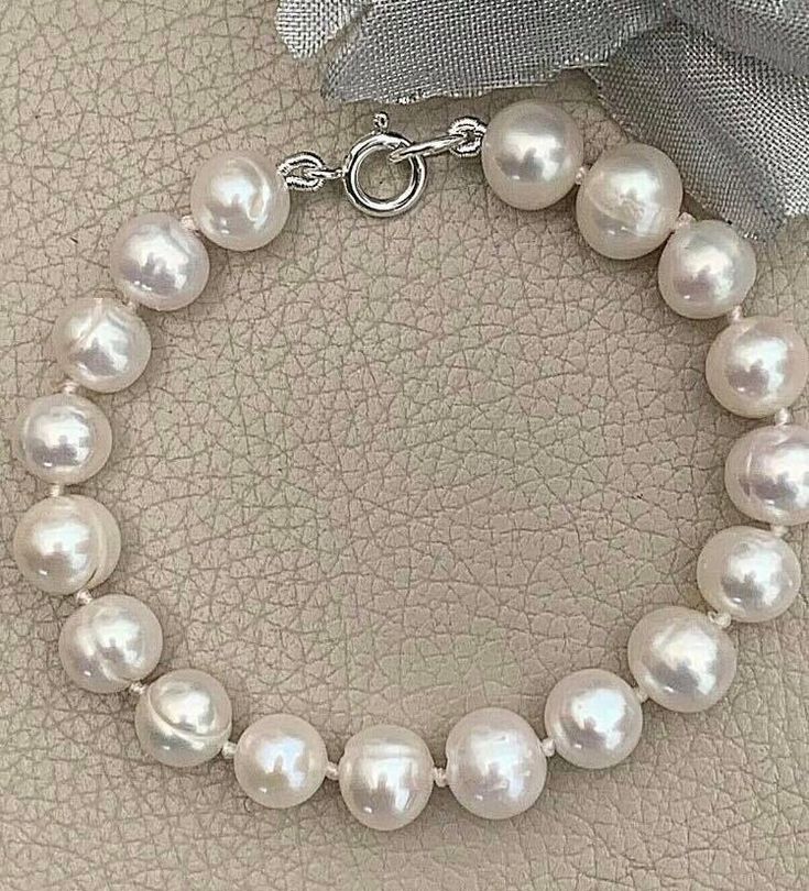 "Freshwater Pearl Bracelet for Women - This is a stunning Handmade in the UK real Pearl Bracelet. A chic bracelet for a special occasion even for a beautiful Bride on her Wedding Day or a stylish and thoughtful Birthday Gift for her. A lovely quality Natural Pearl bracelet. Buying for a gift? Gift wrapping service available for just £2. Design: Gorgeous high lustre White Cultured Pearl Bracelet made with 7-8mm Pearls. The bolt ring clasp is 100% genuine Sterling Silver. Hand strung on silk and i Bracelet For Bride, Real Pearl Bracelet, Pearl Bracelet Wedding, Presents For Wife, Cultured Pearl Bracelet, White Pearl Bracelet, Bolt Ring, Pearl Bracelets, White Pearl Earring