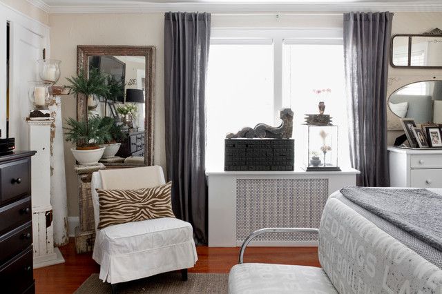 a bedroom with a zebra print chair and mirror on the window sill in front of it