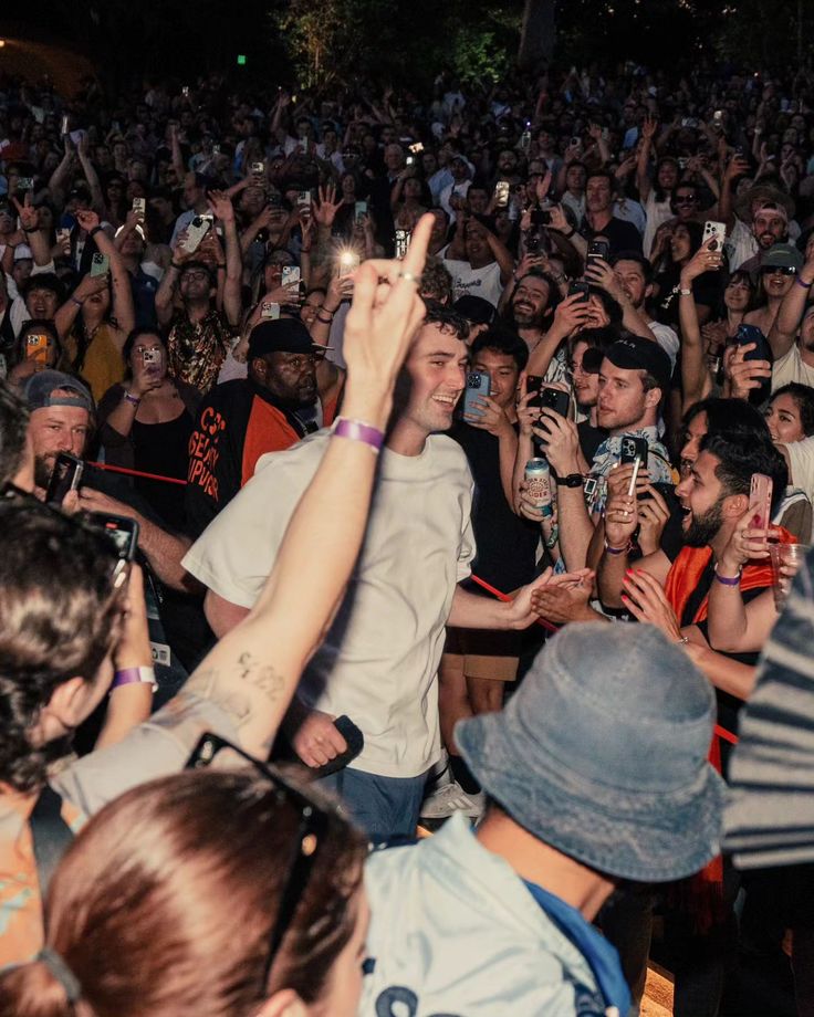 a group of people standing around each other at a concert