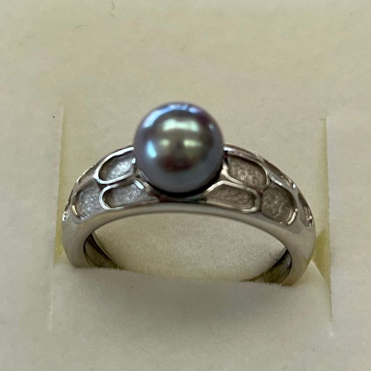 Brand New And Never Worn. Unique Design With Rough Crevices And Shiny Finish. Ring Is A Nice Weight And Solid. All Solid 14kt White Gold. Genuine Cultured Pearl Has Been Treated To A Grey Color. 7 Mm Pearl. Ring Size 6.5.Ring Can Be Sized By Your Jeweler. Shank At Bottom Is 3mm Width. Gold Weight Is 4.2 Grams. Elegant Pearl Ring With Bezel Setting For Formal Occasions, Elegant Pearl Ring With Bezel Setting For Formal Events, Elegant Formal Pearl Ring With Bezel Setting, Elegant Oval Pearl Ring With Bezel Setting, Elegant Silver Pearl Ring With Polished Finish, Elegant Silver Pearl Ring With Prong Setting, Exquisite Hallmarked Pearl Ring For Anniversary, Sterling Silver Pearl Ring For Formal Occasions, Formal Sterling Silver Pearl Ring In Fine Jewelry Style