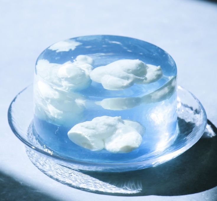 a cake with white frosting sitting on top of a glass plate