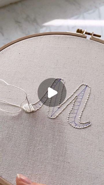 someone is stitching the letters on an embroidery project