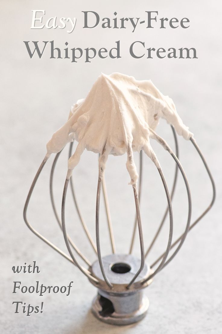 a whisked cream in a metal wire bowl with text overlay that reads easy dairy - free whipped cream with foolproof tips