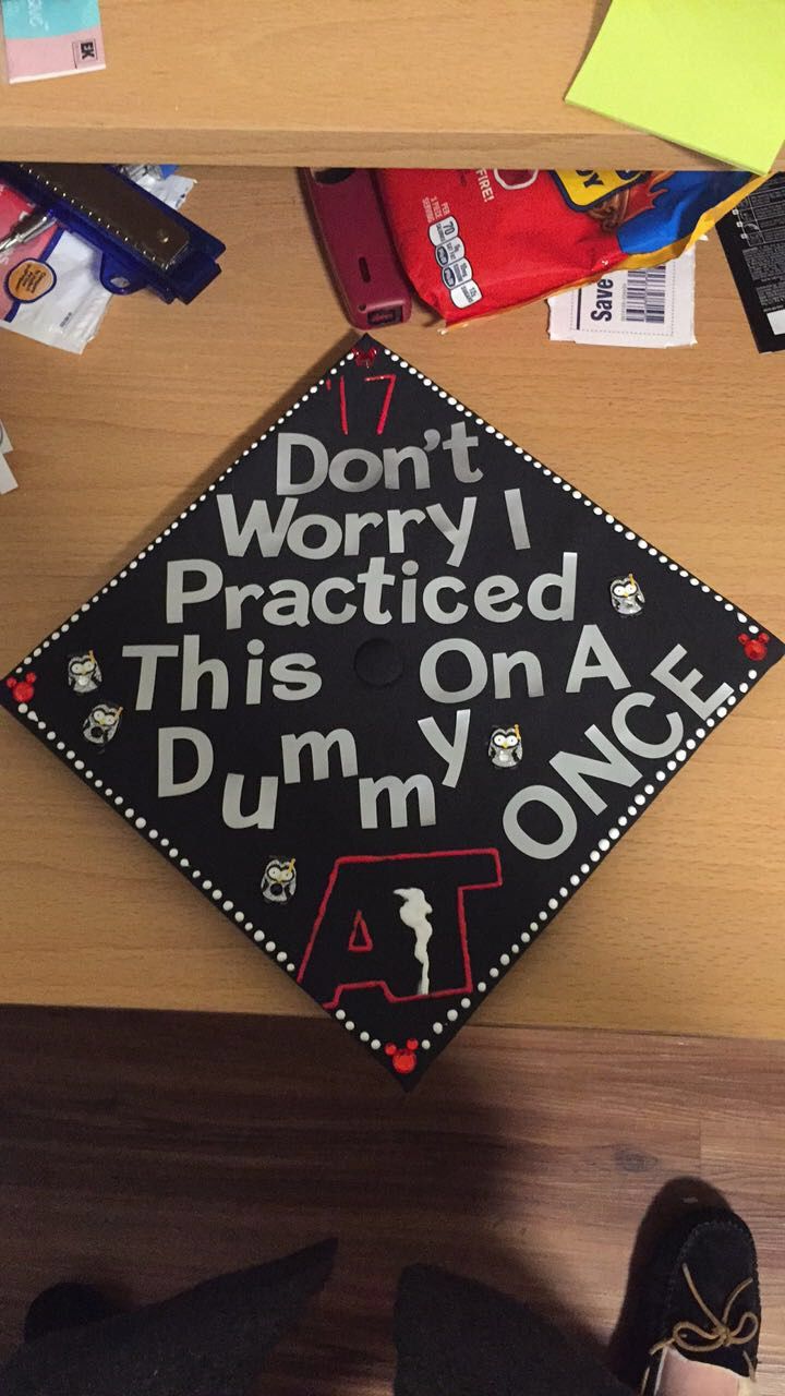 a graduation cap that says don't worry i practice, this is on a desk