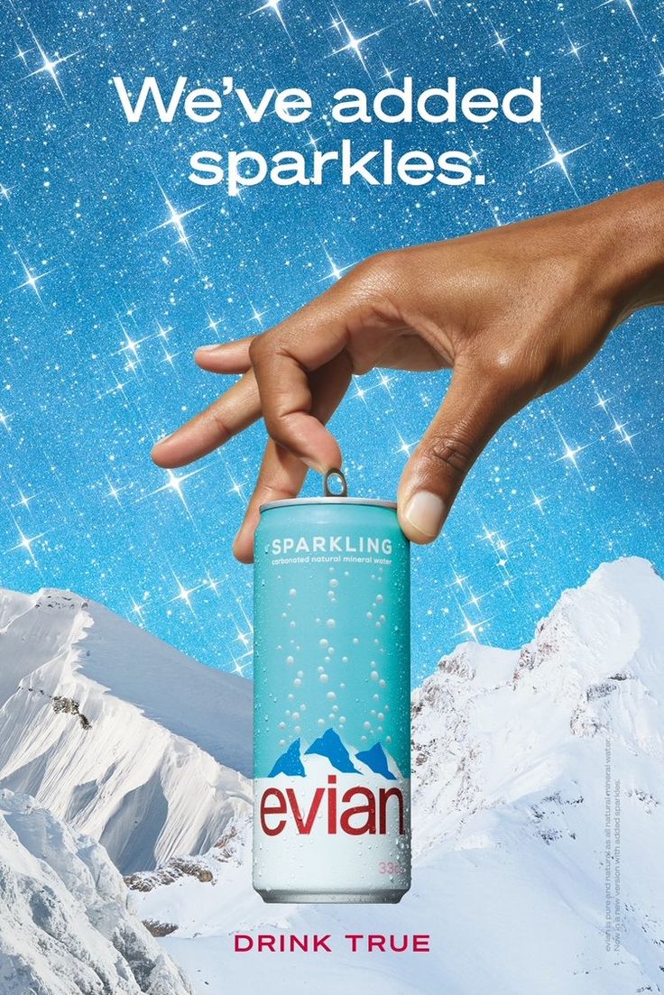 an advertisement for evian sparkling water with a hand reaching out to grab the can