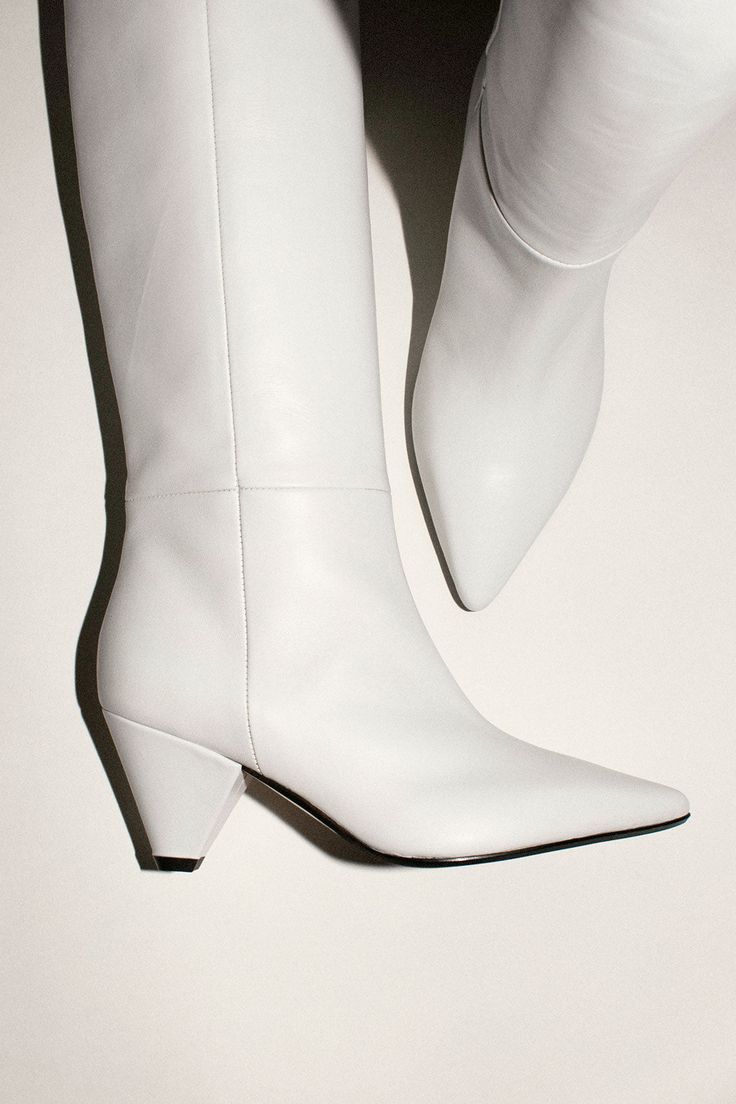 Almond toe white leather knee boot with cone heel. Cone heel measures 3", shaft is 17" tall, and inner circumference measures 14" to 15.5". Fabric is 100% Leather. Leather Knee Boots, Knee Boot, Custom Items, White Leather, Knee Boots, Almond, Shoes Heels, Boots, Heels