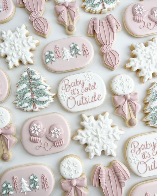 baby shower outside decorated cookies in pastel pinks and white with bows, snowflakes, trees