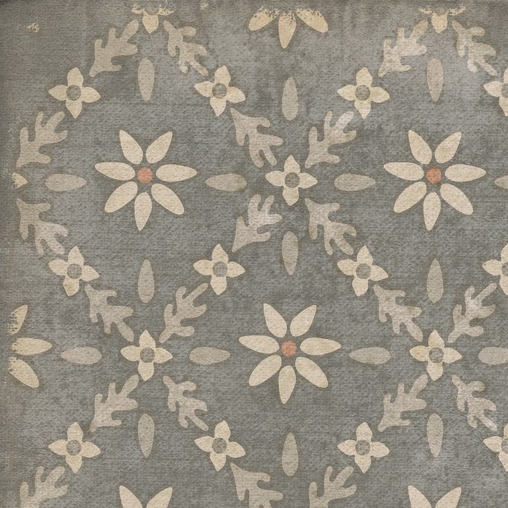 an old rug with flowers and leaves on the ground in front of a gray background