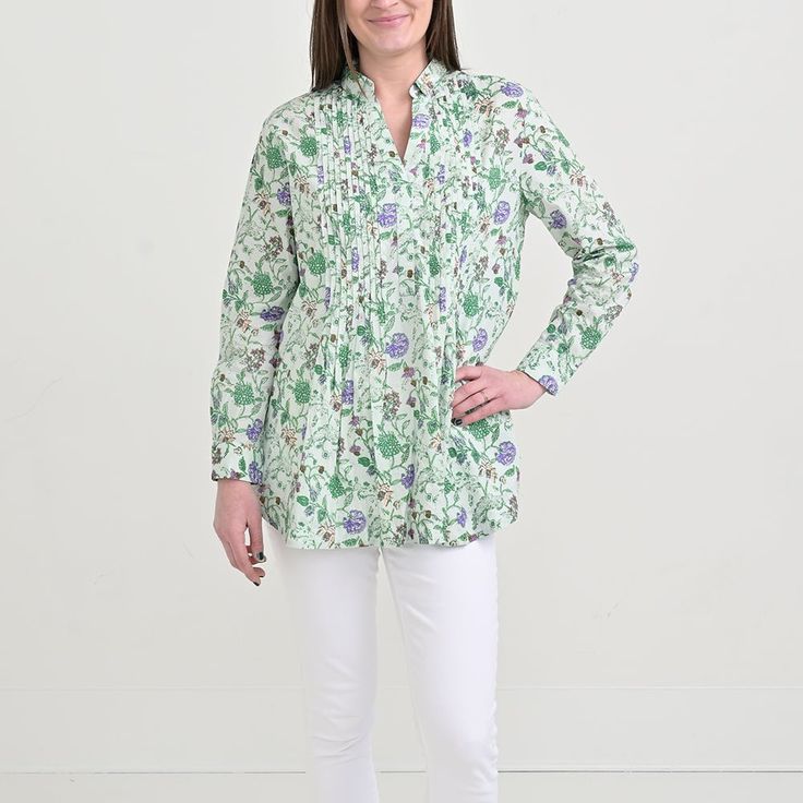 Welcome the Mila Floral Emerald Pintuck Collared tunic to your wardrobe! Crafted with light green cotton in a classic collared silhouette. Accented with delicate pleats at the chest and an enchanting floral pattern in shades of emerald, lavender and light pink, this tunic is sure to make a beautiful statement! FINAL SALE: this item is non-refundable and not eligible for return or exchange. We encourage you to carefully review your selection before completing your purchase. Size Shoulders Length Bust XS 16" 29" 40" S 17" 29 1/2" 42" M 18" 30 1/2" 42" L 18 1/2" 31" 44" XL 19" 31 1/2" 44" Casual Long Sleeve Tops For Garden Party, Green Floral Print Blouse With Relaxed Fit, Green Floral Print Long Sleeve Tunic, Green Long Sleeve Tunic With Floral Print, Classic Split Neck Spring Blouse, Classic Split Neck Blouse For Spring, Fitted Green Tunic For Spring, Classic Green Blouse For Daywear, Green Floral Print Tunic Blouse