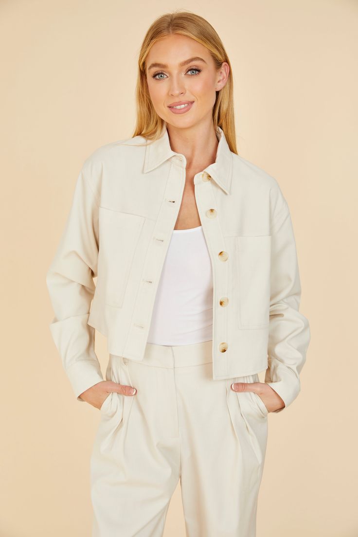 Stay on-trend as you transition to a springtime vibe with our Cream Cropped Jacket. This chic piece, featuring a trendy cropped design and two large front pockets, is a must-have for your spring wardrobe. The neutral cream color makes it the perfect complement to your airy and vibrant spring outfits. Whether paired with jeans or a sundress, this cropped jacket is a great choice for a breezy spring look. Cropped Front pockets Match with Full Leg Trouser style 75406 Dry clean Item # 75405 Sweater Blazer, Trouser Style, Spring Wardrobe, Spring Looks, Romper Dress, Cropped Jacket, Fall Wardrobe, Crop Jacket, Winter Wear