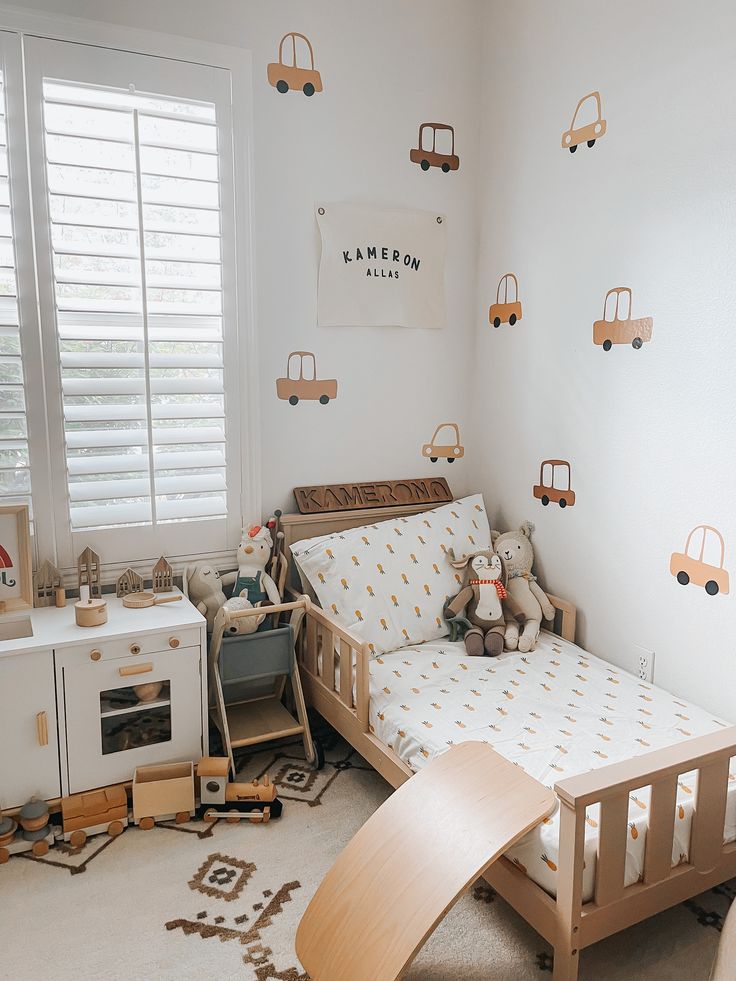 a child's bedroom with toy cars on the wall