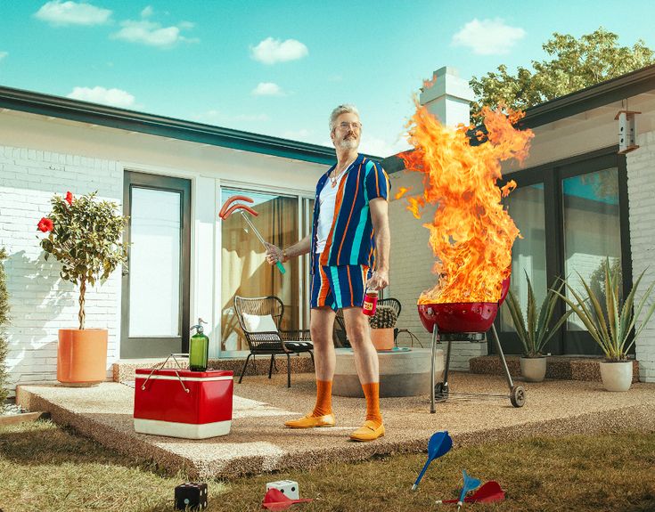 a man standing in front of a fire pit