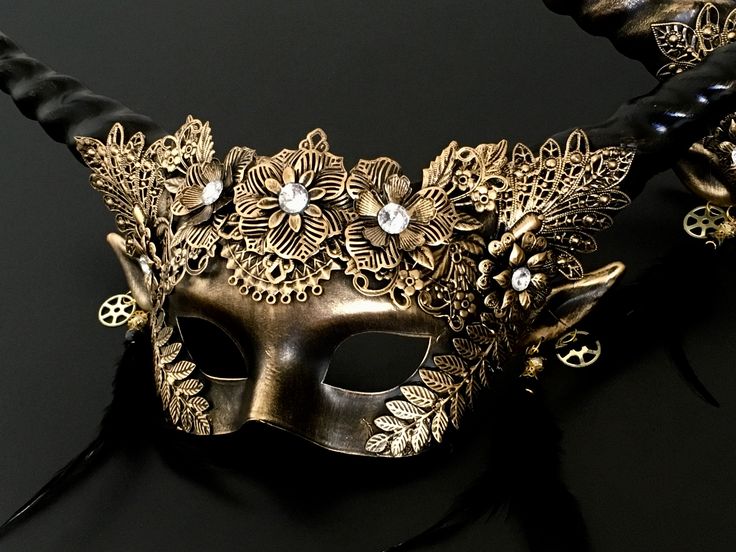 The twirling venetian mask has black/gold horns jutting out from the sides and animal-inspired mask for women in gold is bifurcated by eye design: metallic floral/brocaded patterns. Perfect for any event or function. Fantasy Horned Costume Accessories For Masquerade, Gold Costume Masks For Halloween, Gold Fantasy Masquerade Mask For Party, Gold Fantasy Style Masquerade Mask For Party, Fantasy Horned Masquerade Mask For Costume, Gothic Gold Masks And Prosthetics For Costume, Gold Eye Mask For Halloween Masquerade, Fantasy Horned Masks For Masquerade, Fantasy Gold Masks And Prosthetics For Halloween