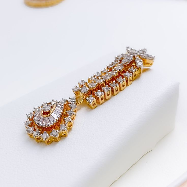 This exquisite 18k gold set, weighing 48.3 grams, features an opulent leaf-adorned design adorned with dazzling diamonds. The yellow gold finish enhances its luxurious appeal, making it perfect for any special occasion. The set includes a necklace with a total diamond weight of 7.47 carats, featuring F-G color and VS quality diamonds in round and tapered baguette shapes. The necklace has a length of 16.5 inches with a 1-inch drop length, adjustable 1-inch links, and a secure hook lock. The match Gold Elegant Cubic Zirconia Diamond Earrings, Luxury Gold Diamond Earrings With Single Cut Diamonds, Luxury Gold Diamond Earrings With Single Cut, Diamond White Gold-plated Earrings For Wedding, Wedding Diamond White Gold-plated Earrings, Wedding Diamond White Gold Plated Earrings, Diamond Pendant Jewelry Sets For Anniversary, Gold Marquise Diamond Earrings With Brilliant Cut, Gold Marquise Brilliant Cut Diamond Earrings