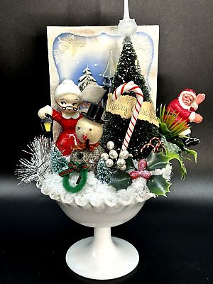 a white bowl filled with christmas decorations and candy canes on top of a table