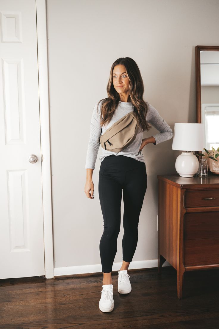 ashley wearing a gray tee, olive green belt bag, black leggings, and white sneakers standing next to a vintage wood dresser with a white table lamp Mini Capsule Wardrobe, Outfits Leggins, Mom Outfits Fall, Winter Outfits Casual, Walking Outfits, Outfits For Work, Moda Chic, Fall Mini, Estilo Preppy