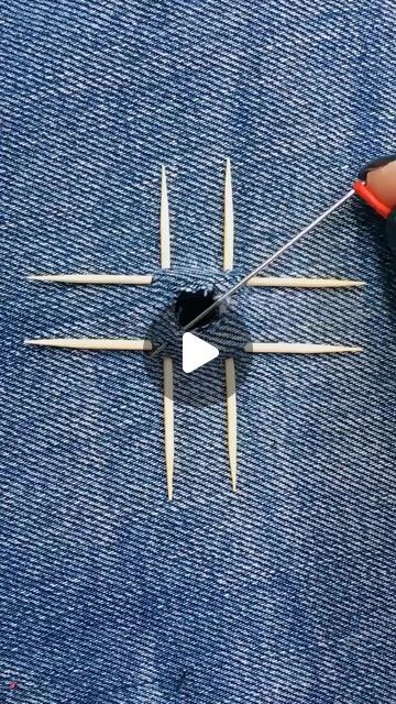 someone is making a clock out of blue jeans and some toothpicks on it