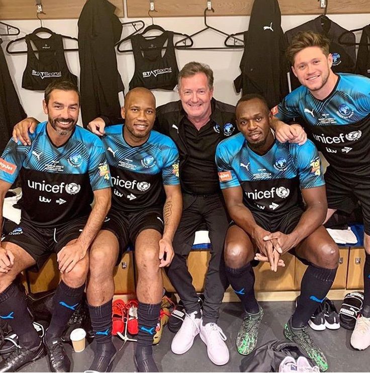 the rugby team is posing for a photo in front of their dressing room lockers