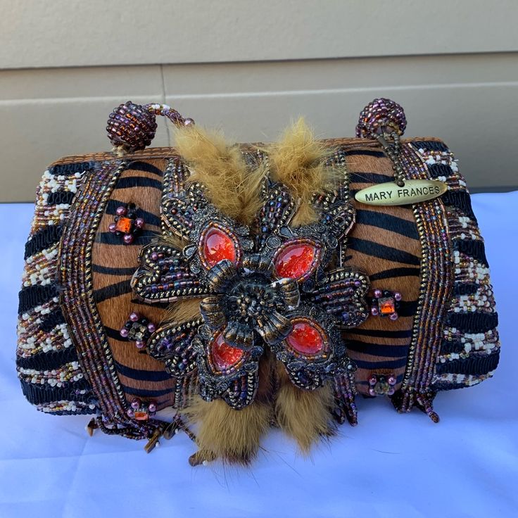 the purse is decorated with beads and feathers