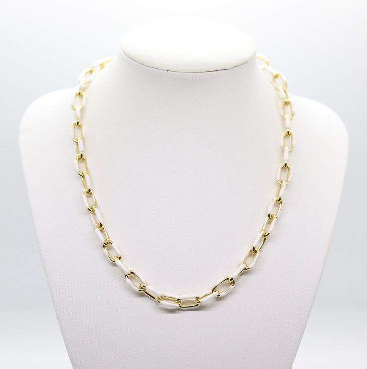 The White and Gold Chain Necklace is a sophisticated piece of jewelry, featuring alternating links of elegant white and shimmering gold. This combination creates a timeless and versatile accessory, suitable for both casual and formal attire. White Oval Link Necklace For Formal Occasions, White Necklaces With Gold Chain For Formal Occasions, Formal White Necklaces With Gold Chain, Formal White Chain Necklace With Adjustable Chain, White Gold Chain Necklace For Formal Occasions, White Chic Chain Necklace With Adjustable Chain, Chic White Chain Necklace With Adjustable Chain, Elegant White Link Jewelry, Chic White Necklace With Gold Chain