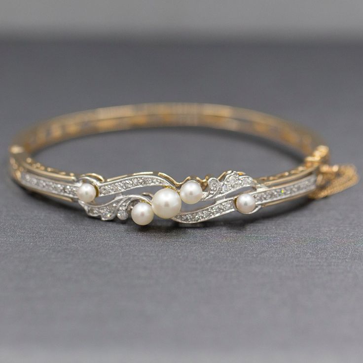 "Exquisite Art Deco Cultured Pearl and Diamond Bangle Bracelet in 14k Yellow Gold This stunning bracelet is a perfect period piece in exquisite condition.  The bracelet features a bangle design with a hinged opening at the side.  The top of the bracelet is encrusted with diamonds and pearls.  The pearls and cultured and measure 6.14mm (largest and 3.84 (smallest).  The design features single cut round diamonds, thirty two of them.  The stones are VS/SI clarity and are G/H color.  They measure 1. Antique Diamond Accented Bracelets For Anniversary, Elegant White Bracelets For Ceremonial Occasions, Elegant White Ceremonial Bracelets, Classic Diamond Bracelet With Oyster Style For Wedding, Classic Diamond Oyster Bracelet For Wedding, Formal Diamond Bangle Bracelet With Oyster Detail, 14k Gold Oyster Bracelet Bangle For Formal Occasions, Elegant Oval Hallmarked Bangle, Vintage Formal Bangle Hand Set