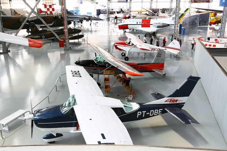 several small airplanes are on display in a museum