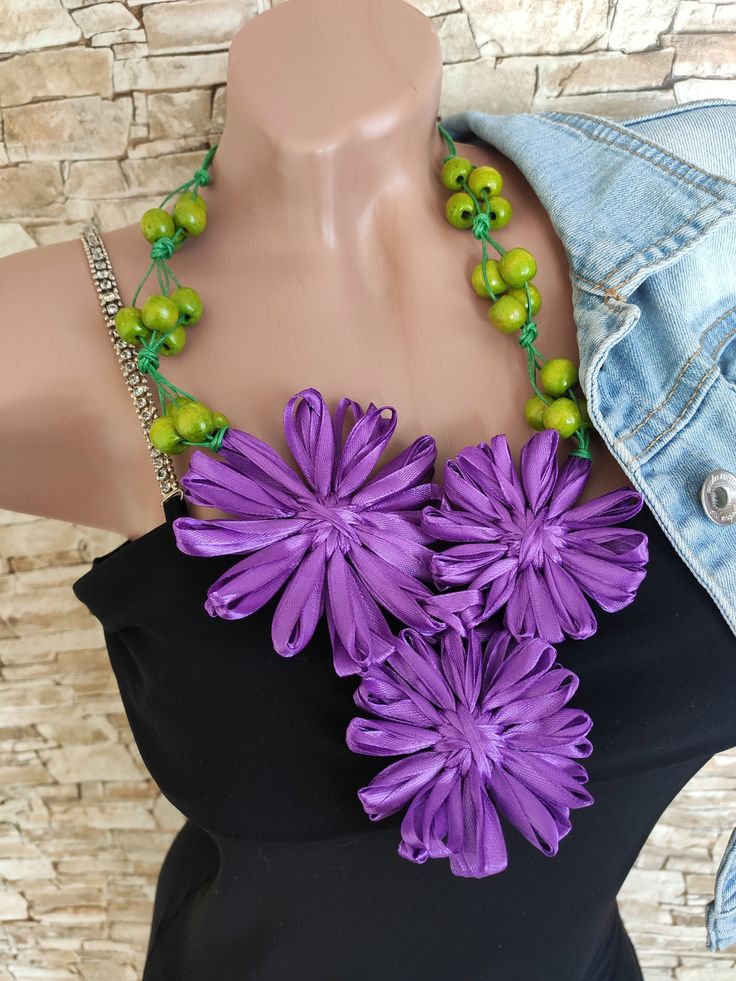 Statement necklace which is will attract attention. Flowers ultraviolet & green necklace, which is speaks for itself. This colorful necklace, which is completely transform any the imagee. This is chunky beads necklace will look beautiful with almost any clothing. His can be worn with your favorite T-shirt or blouse. With jeans, a skirt, a dress - it's a ribbon necklace, harmoniously everywhere. This bohemian necklace perfect for bohemian style or the style of the hippie. Eco jewelry. For you, wi Green Flower Decoration Jewelry For Party, Handmade Green Beaded Necklace For Spring, Purple Necklace For Spring Gift, Green Handmade Bib Necklace For Parties, Handmade Necklaces For Spring Parties, Handmade Green Necklaces For Spring, Unique Flower Necklaces For Party, Bohemian Green Flower Necklace, Green Necklaces For Summer Parties