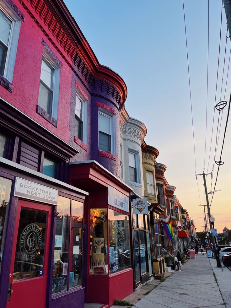 a row of multi - colored buildings on a city street